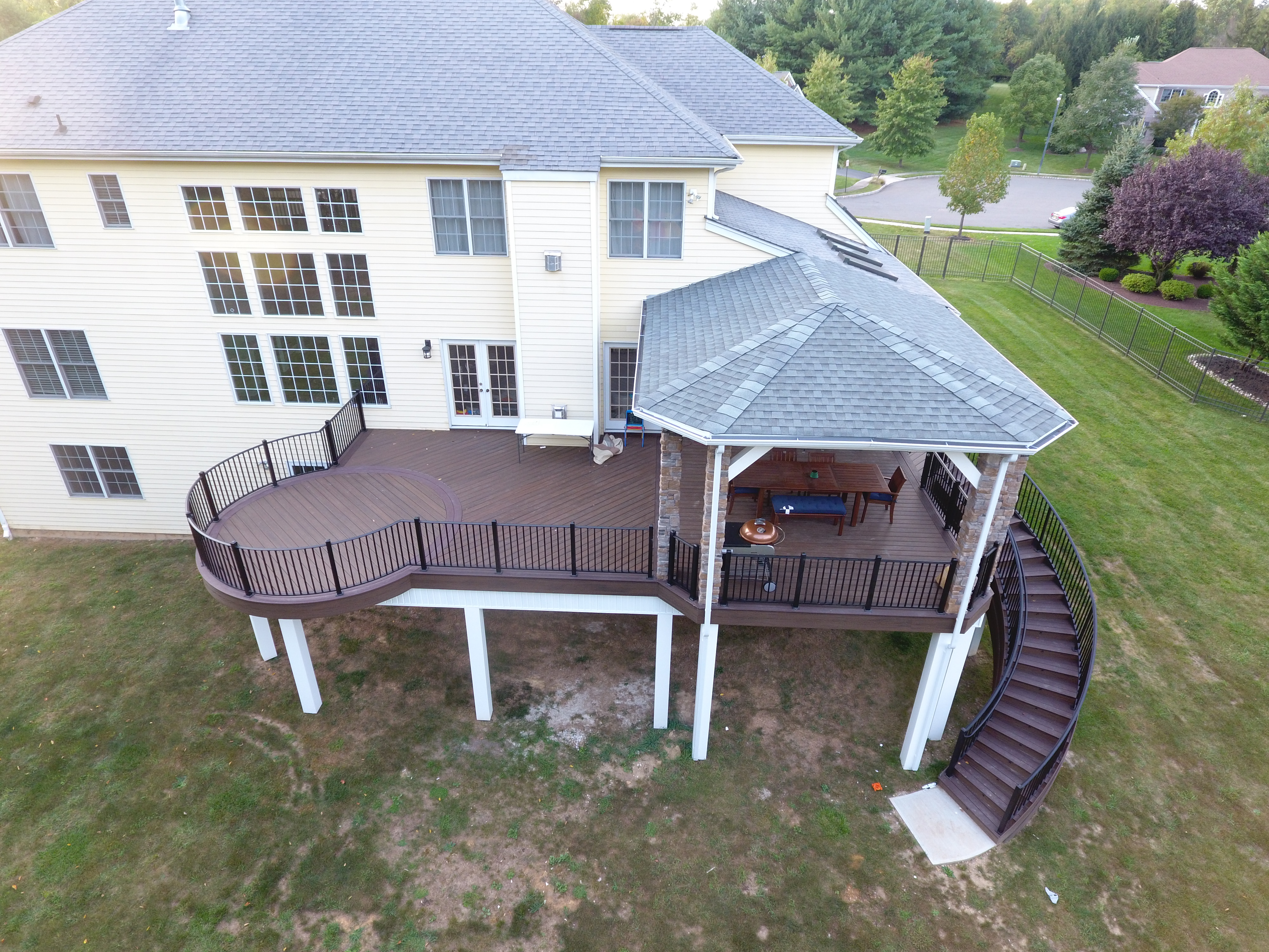 State of the Art Trex Deck, Curved Stairs, Hip-Roof